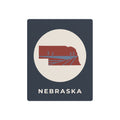 Nebraska state metal wall art sign with circular farm illustration and “NEBRASKA” text