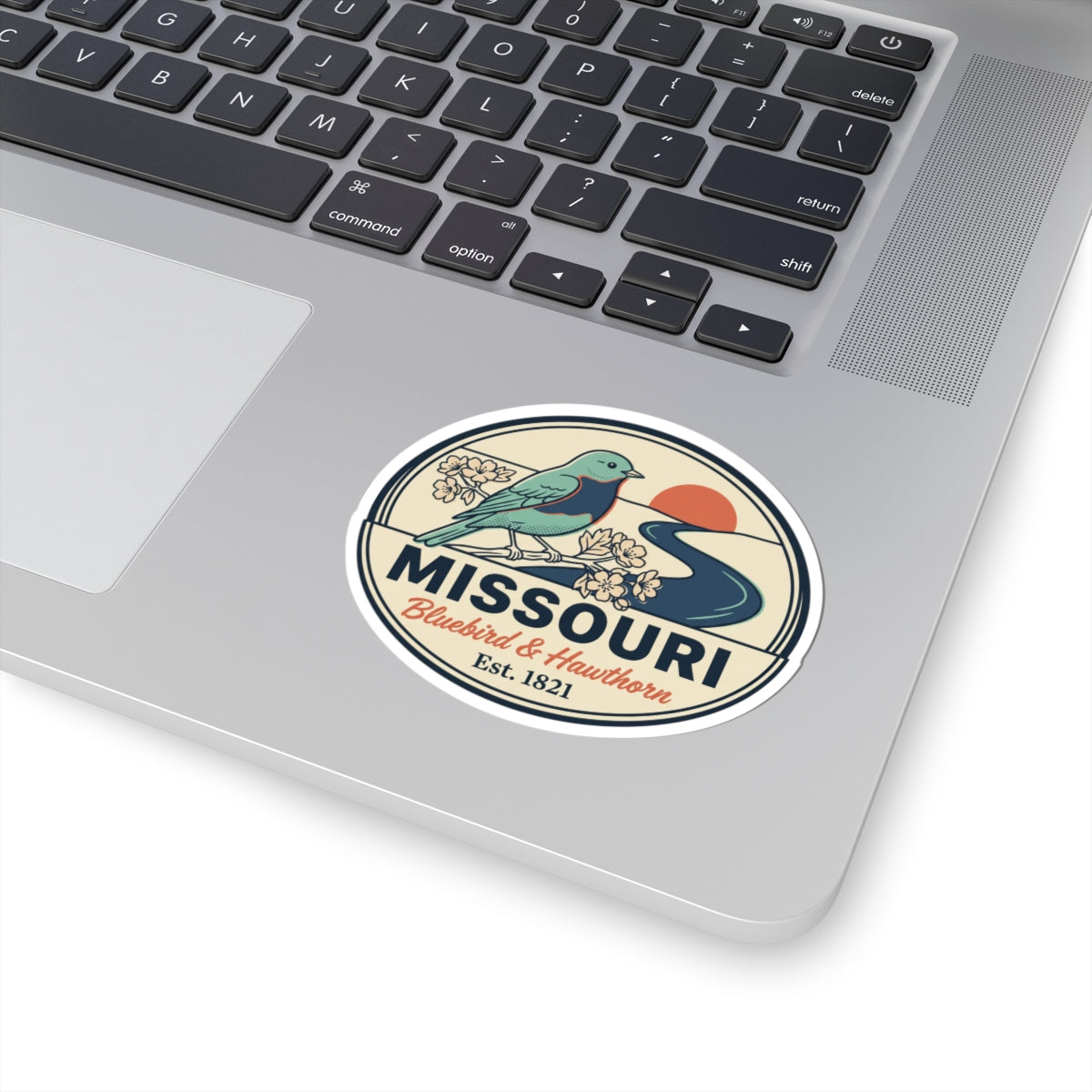 Round Missouri state badge sticker featuring a teal bluebird, flowers, and “Est. 1821”