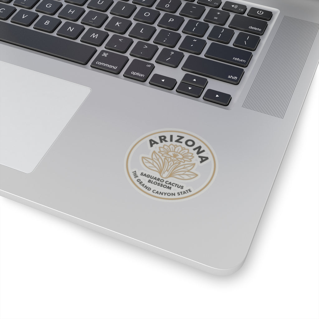 Saguaro cactus blossom sticker on a laptop lid, circular Arizona seal in beige on clear.