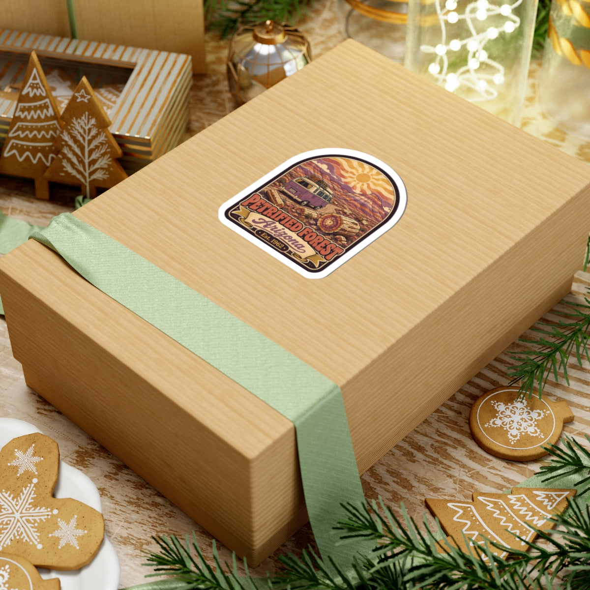 Kiss-cut desert camper van sticker on a wrapped gift box, 'Petrified Forest Arizona Est. 1962'.