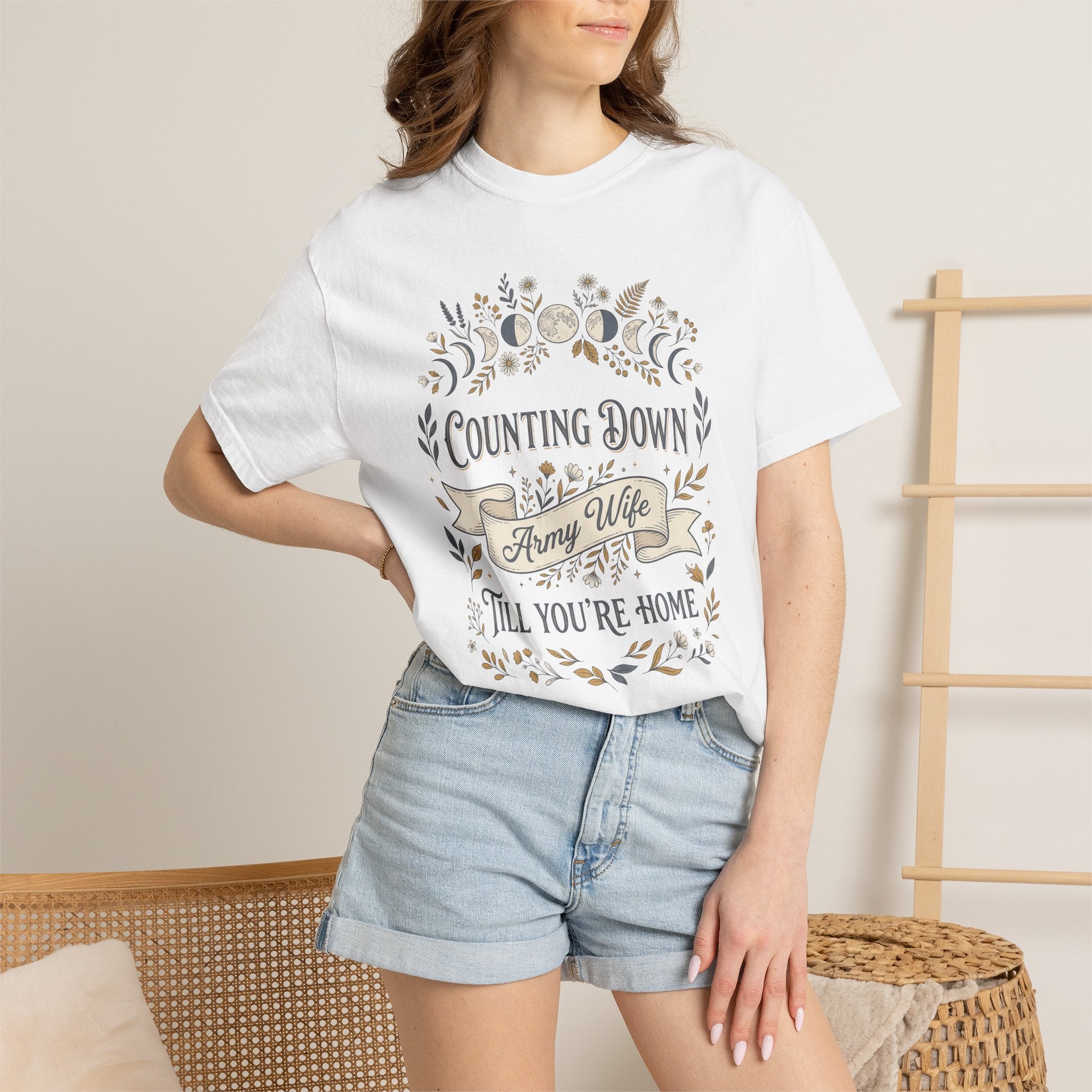 Model wearing a white army wife countdown T-shirt with floral “Counting Down” graphic