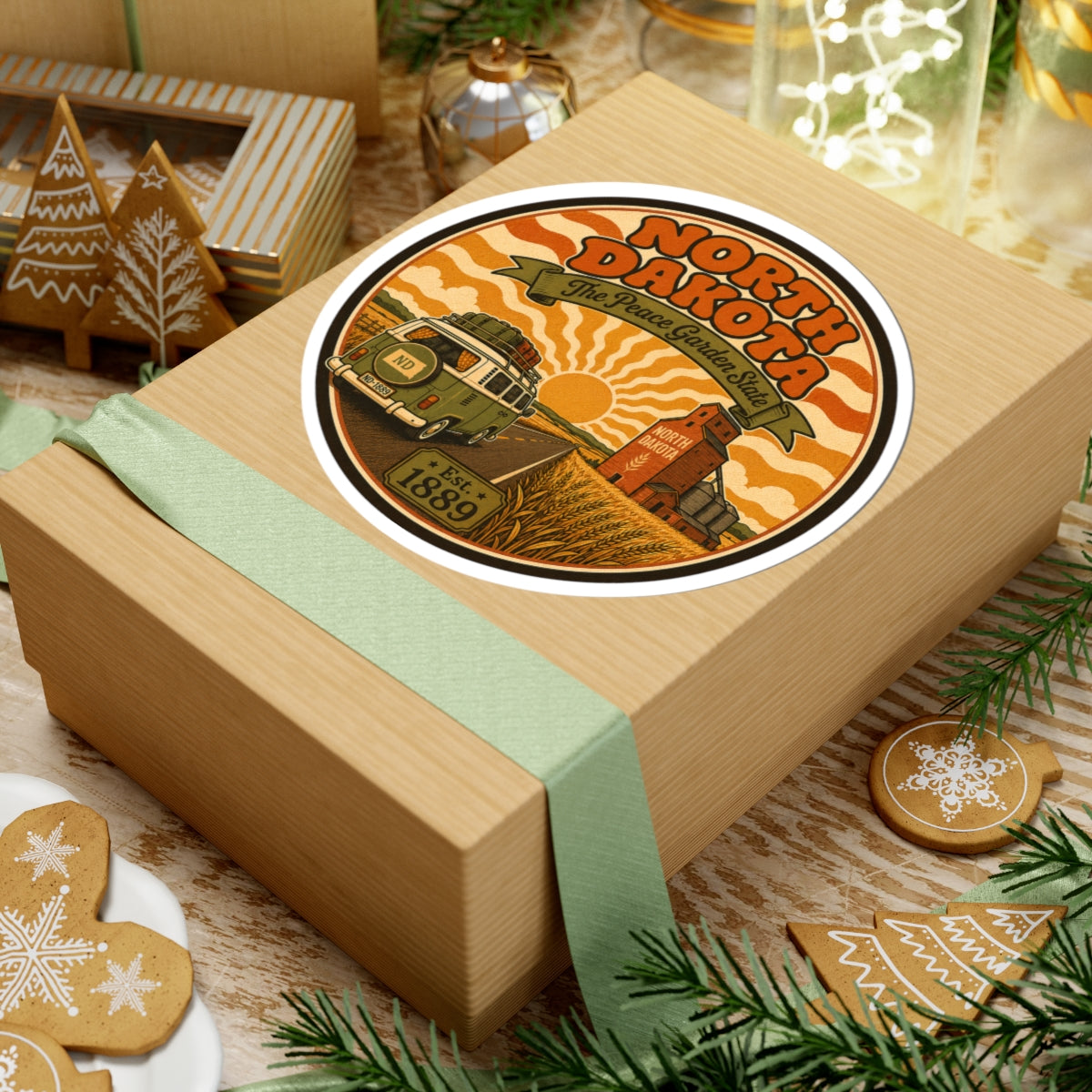 Round North Dakota travel decal with orange waves, wheat field, truck and Est. 1889