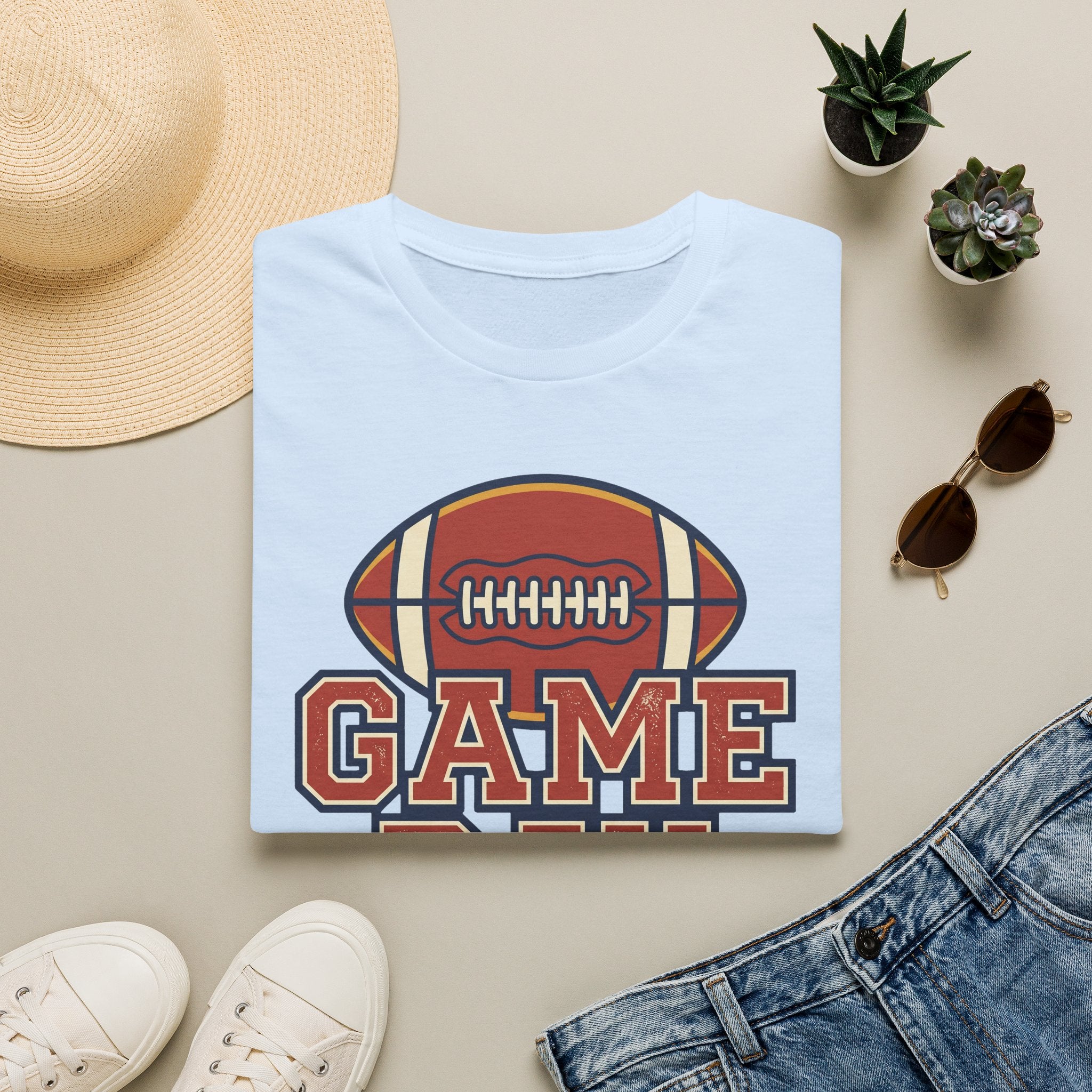 Light blue football t-shirt with “GAME” text and football emblem graphic on center front