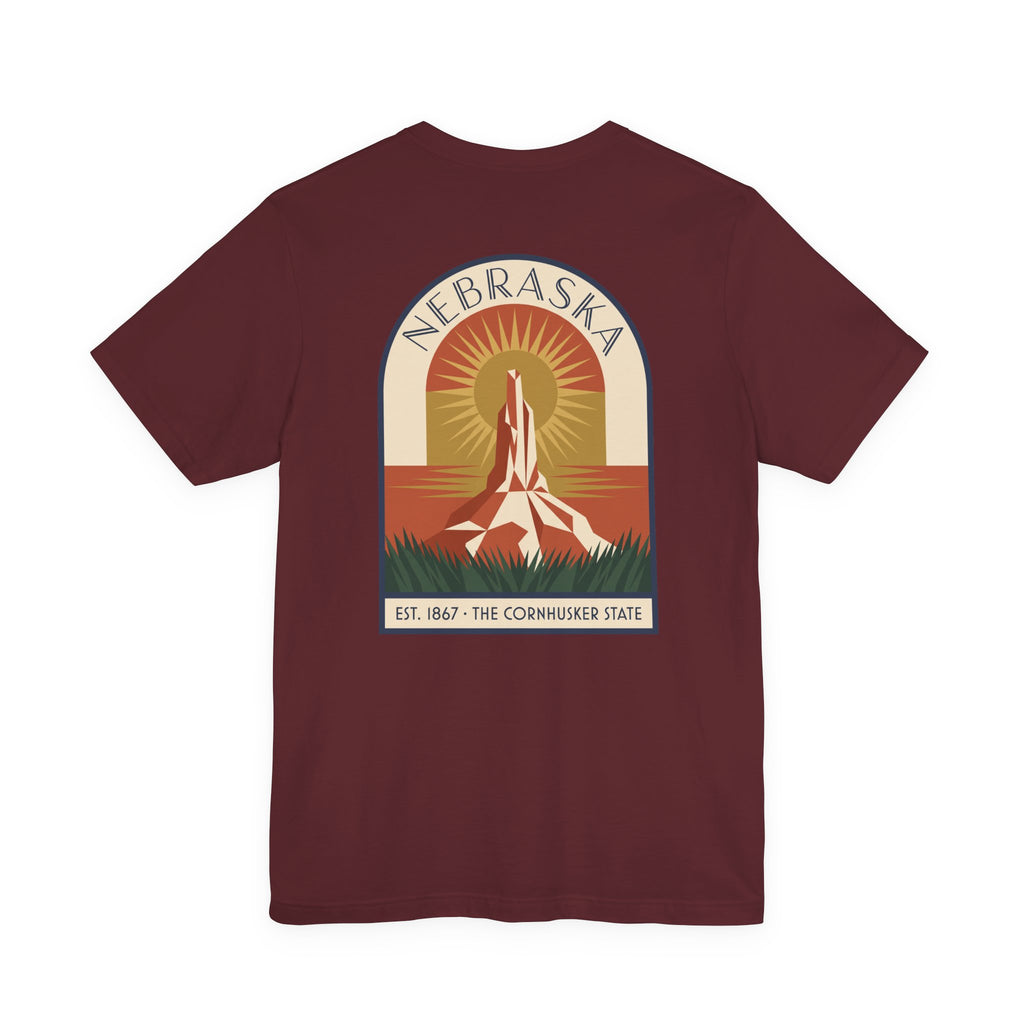 Burgundy Nebraska graphic T-shirt with art deco tower and sunset badge