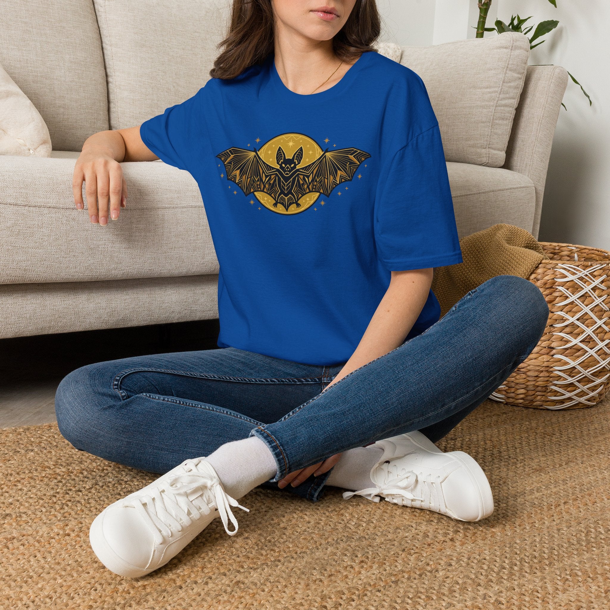 Royal blue T-shirt worn with gold bat and moon graphic on the chest