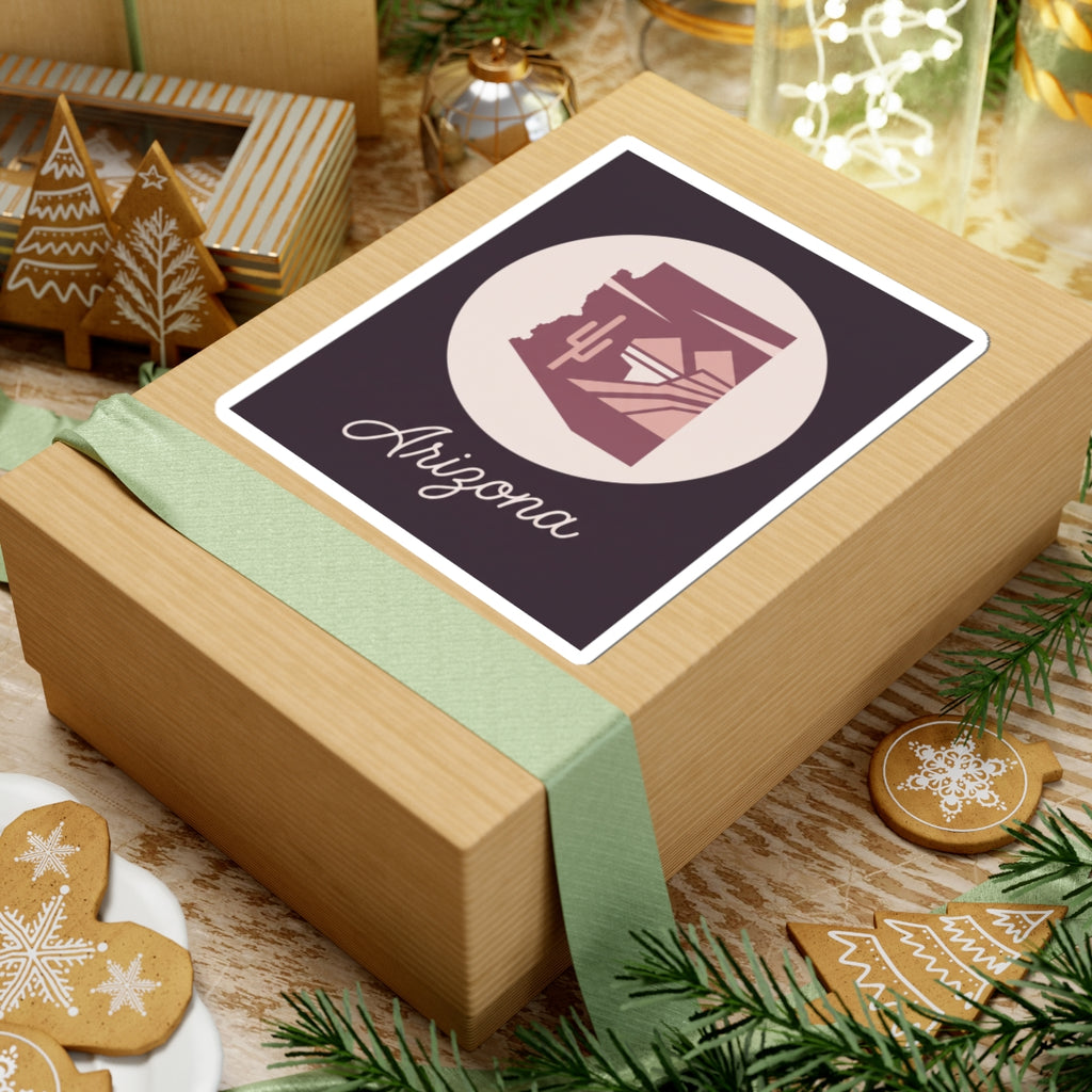 Mauve Arizona state silhouette sticker on gift wrap with cream circle and cursive 'Arizona'