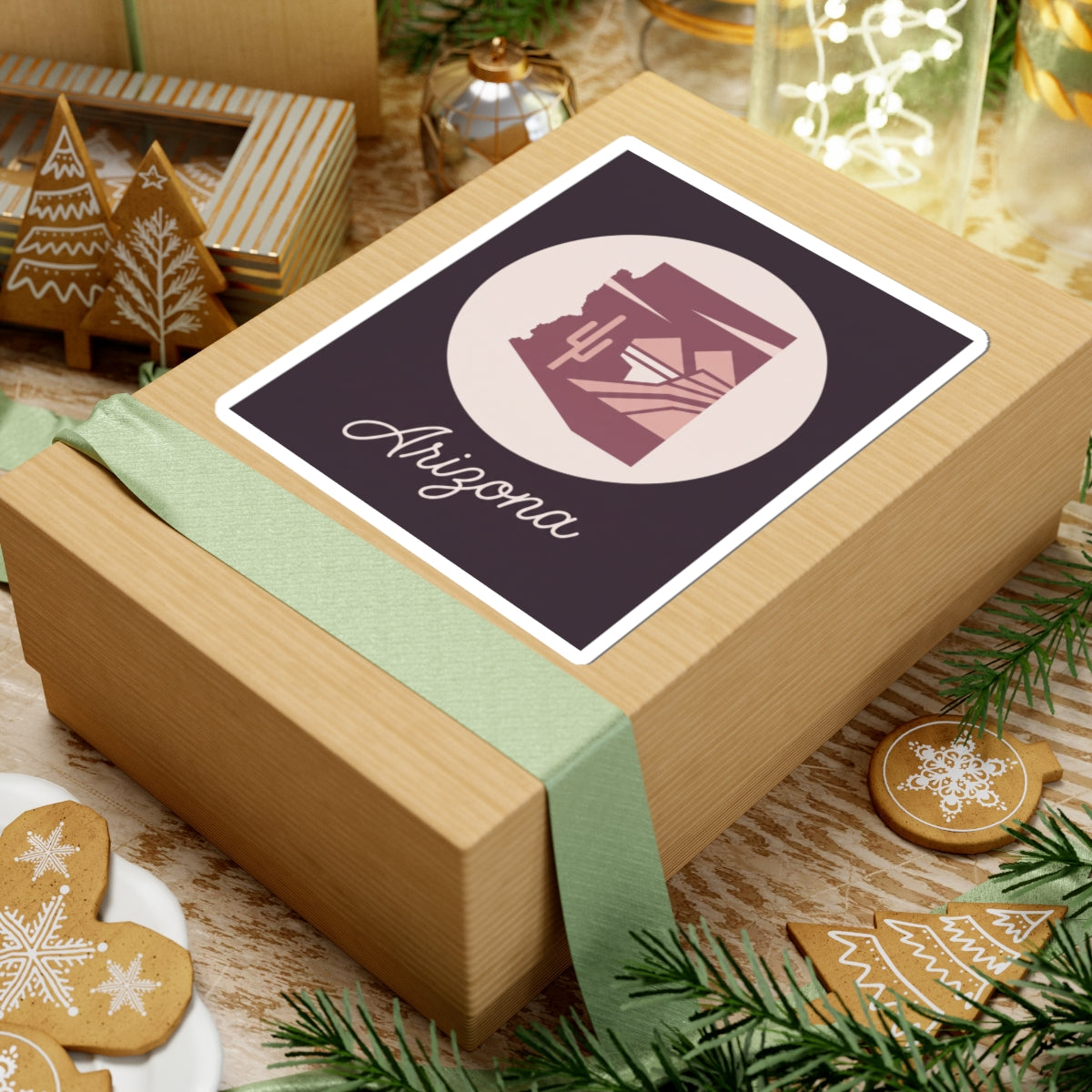 Mauve Arizona state silhouette sticker on gift wrap with cream circle and cursive 'Arizona'