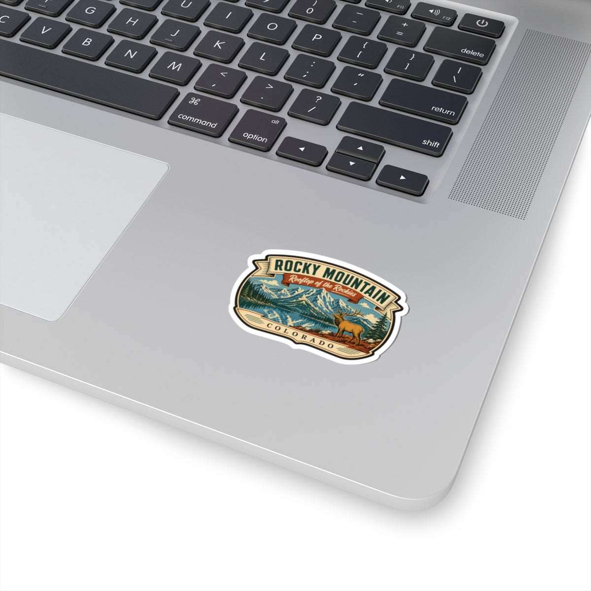 Round Rocky Mountain travel sticker with elk landscape and “Colorado” text, white border