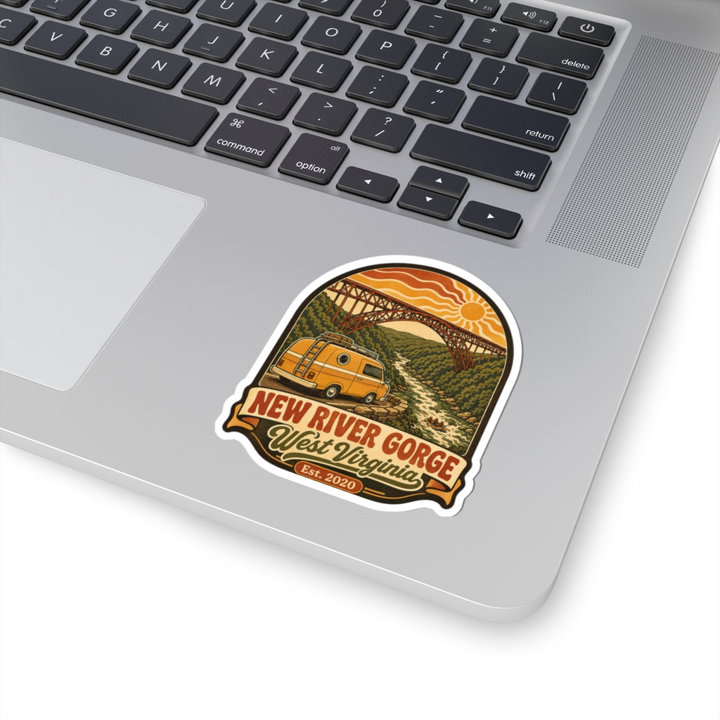 Die-cut travel sticker of yellow van under a steel arch bridge with orange sun and text.