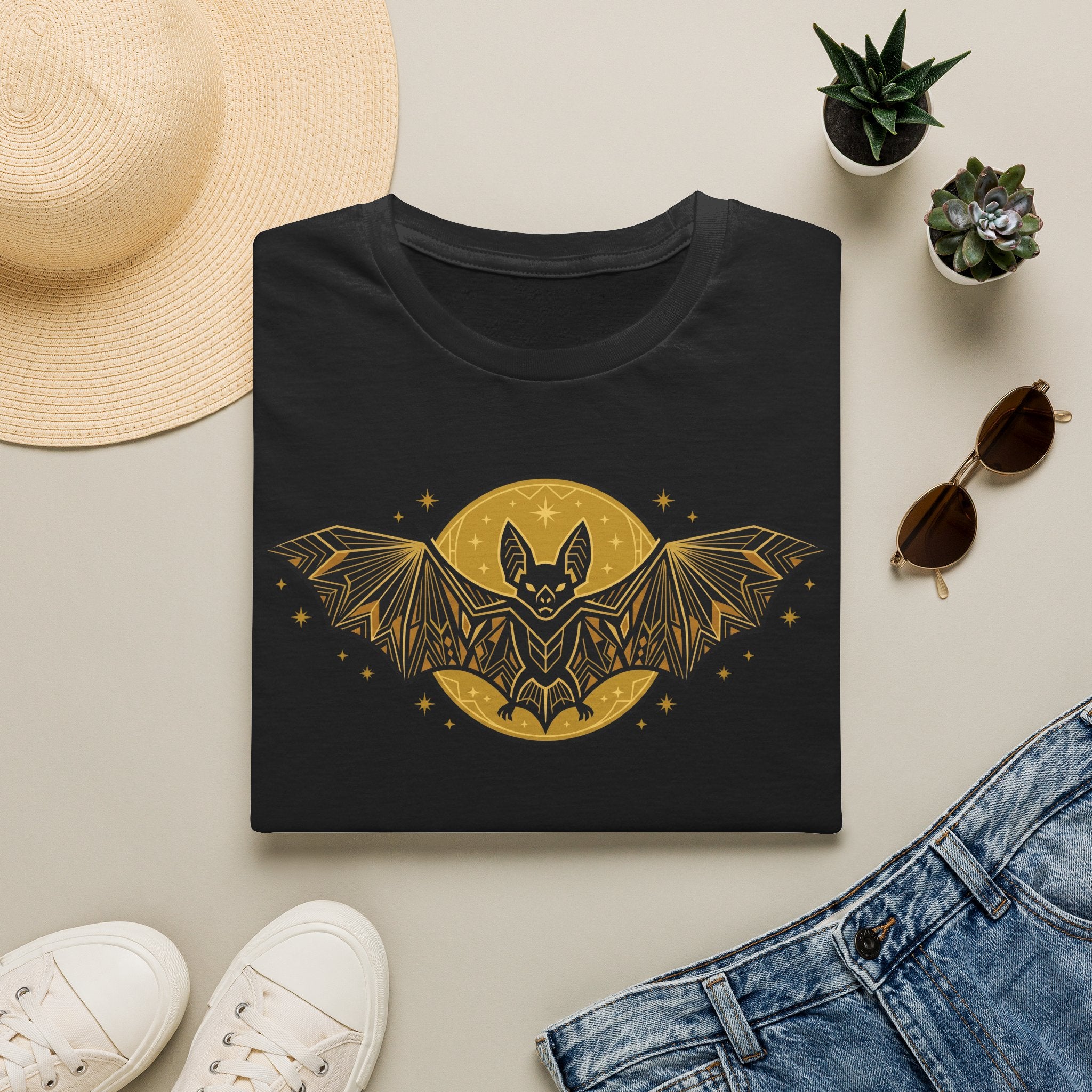 Black crew-neck t-shirt with gold bat-and-moon graphic on the front