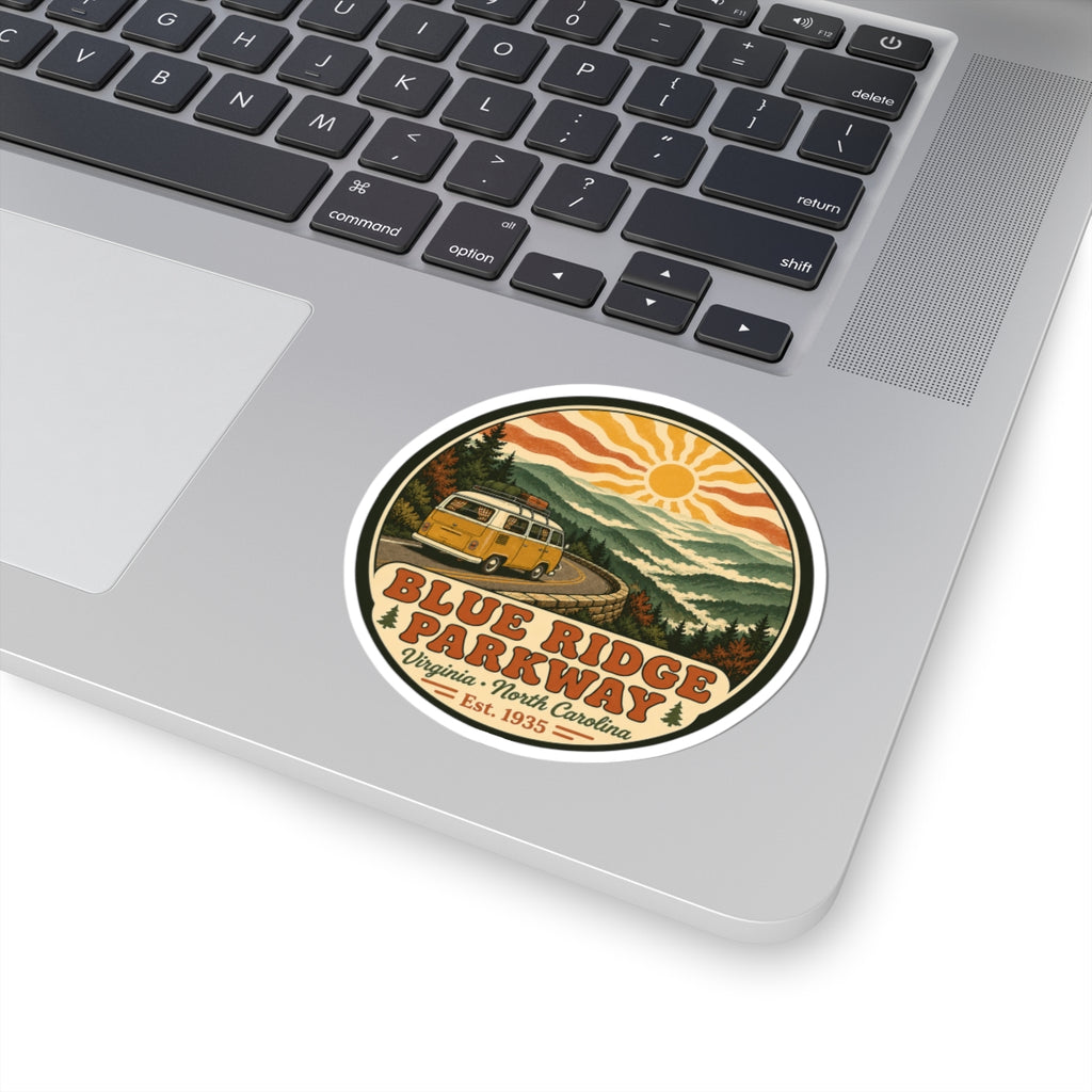 Round Blue Ridge Parkway sticker with yellow camper van, winding road, mountains and sun graphic
