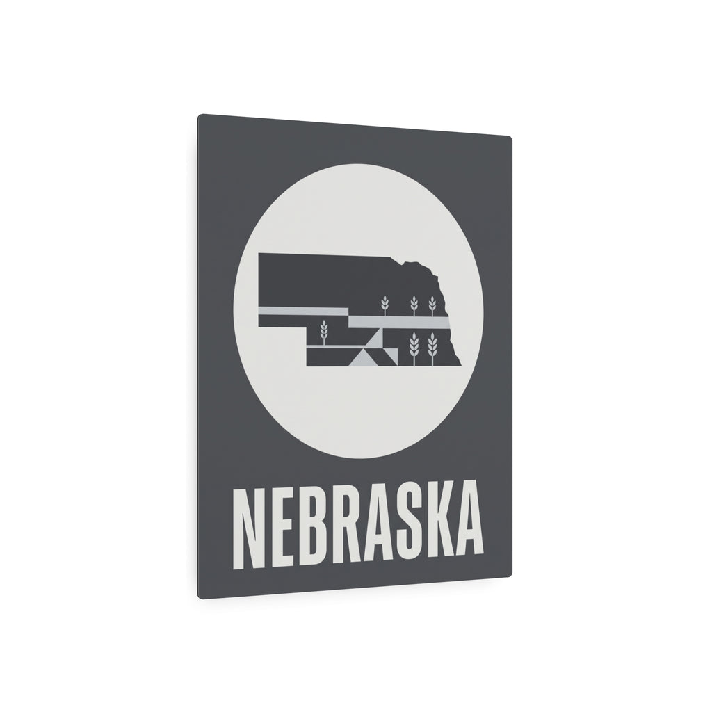 Nebraska metal art sign with dark square frame, circular wheat graphic, and bold NEBRASKA