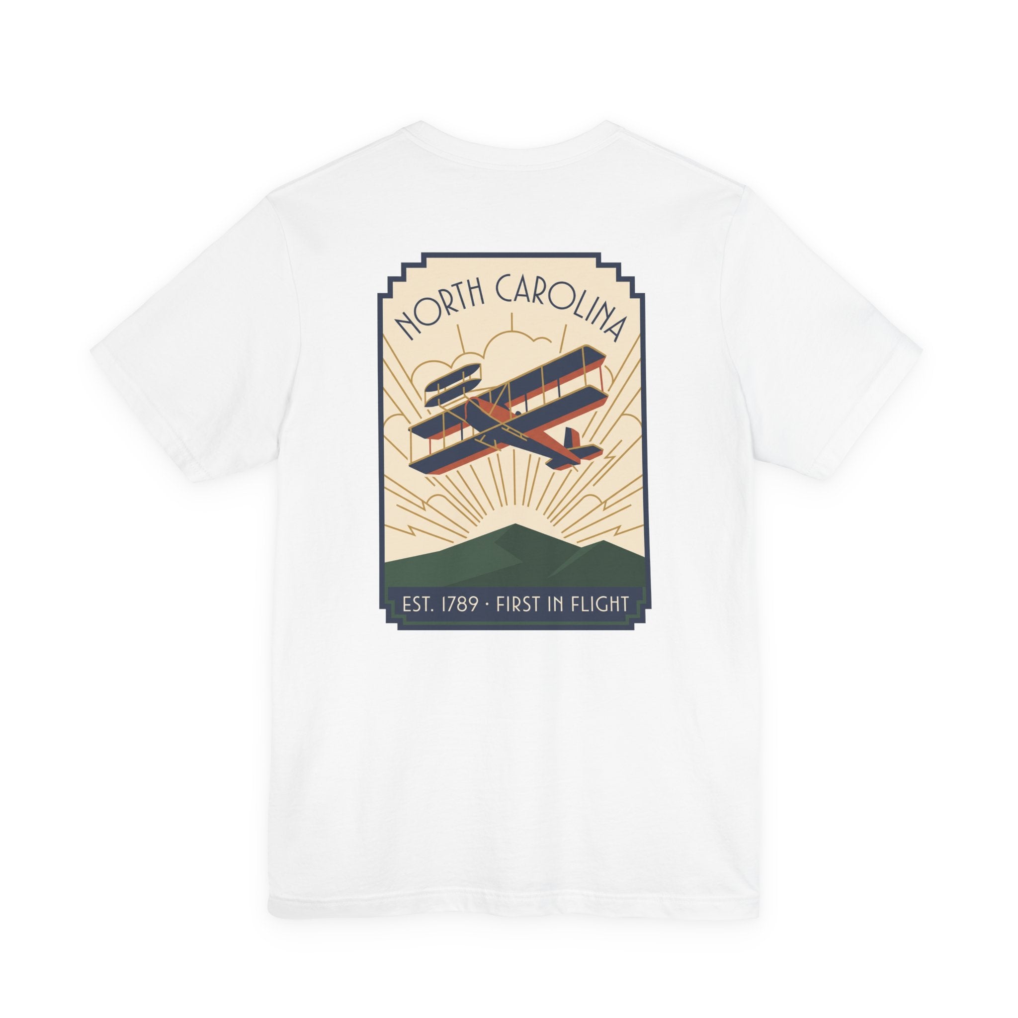White t-shirt with North Carolina biplane graphic and 'Est. 1789 - First in Flight' text