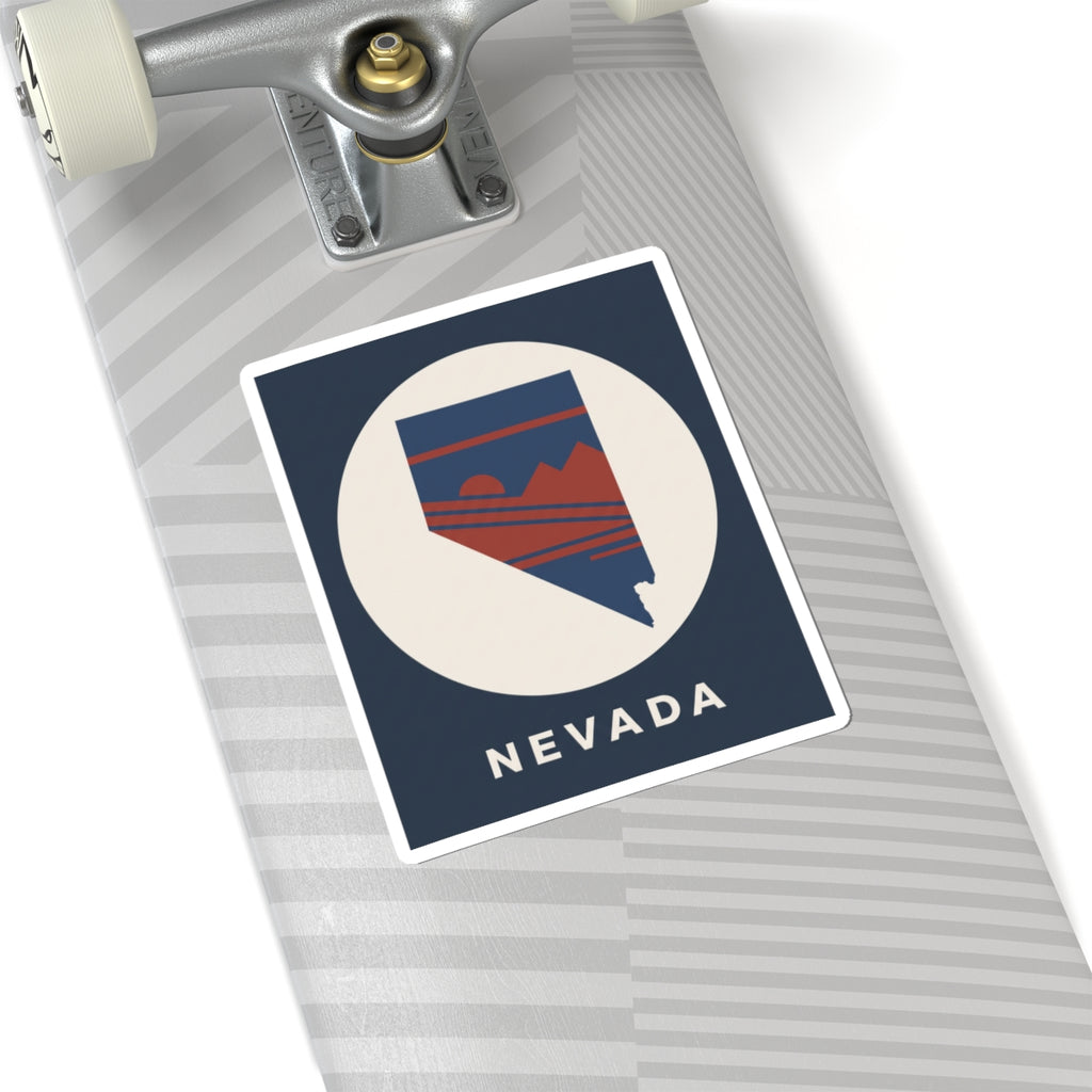 Nevada state kiss-cut sticker on a laptop surface, navy square with retro mountain emblem