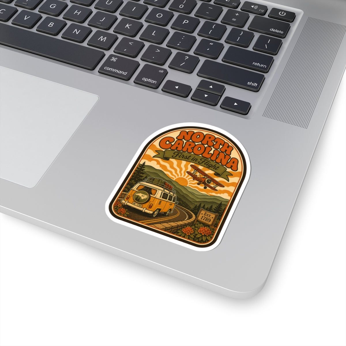 North Carolina vintage van and biplane sticker on white laptop trackpad, die-cut