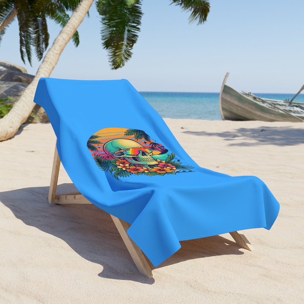 Blue beach towel on chair with colorful skull and floral tropical design