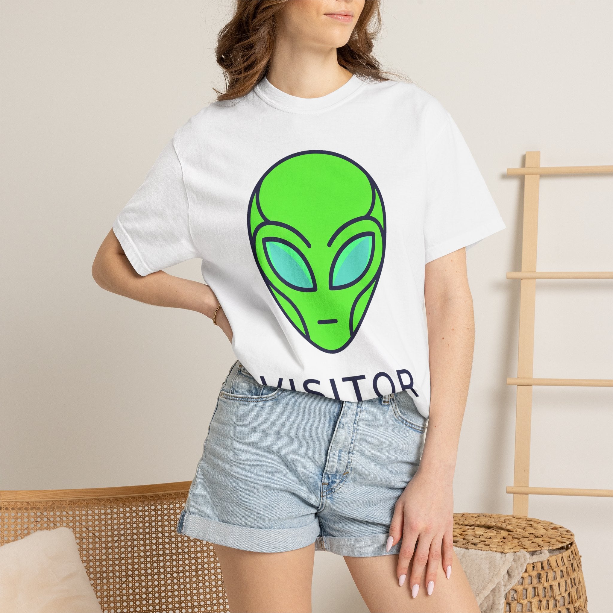 Alien face graphic T-shirt in white with neon green and blue print at center chest