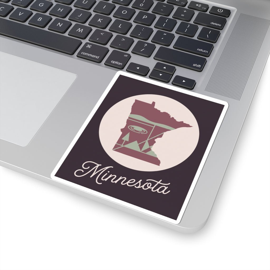 Minnesota state silhouette sticker on laptop lid, with circular lake graphic and “Minnesota”