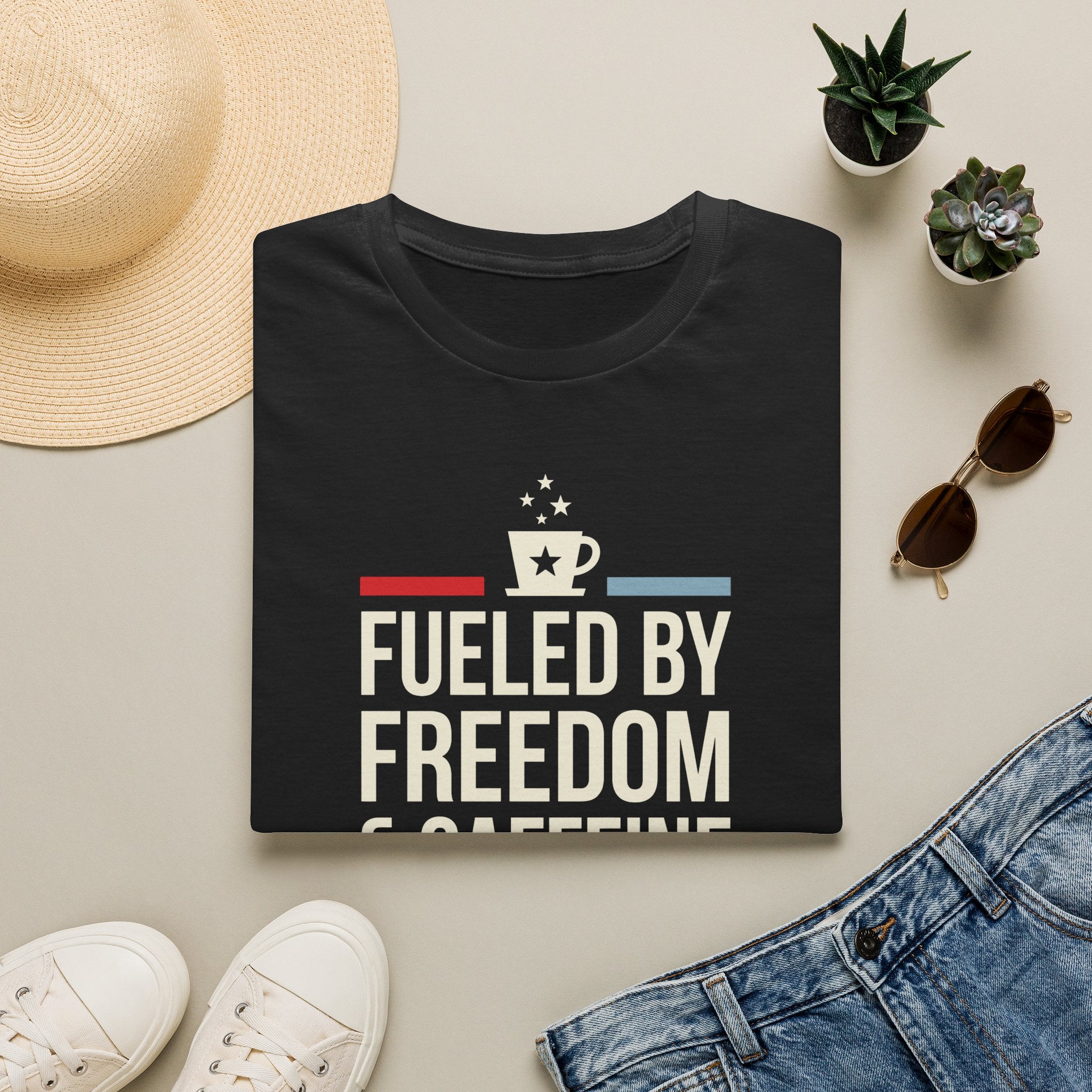 Dark T-shirt with “Fuelled by Freedom” graphic, coffee cup icon, red and blue stripes