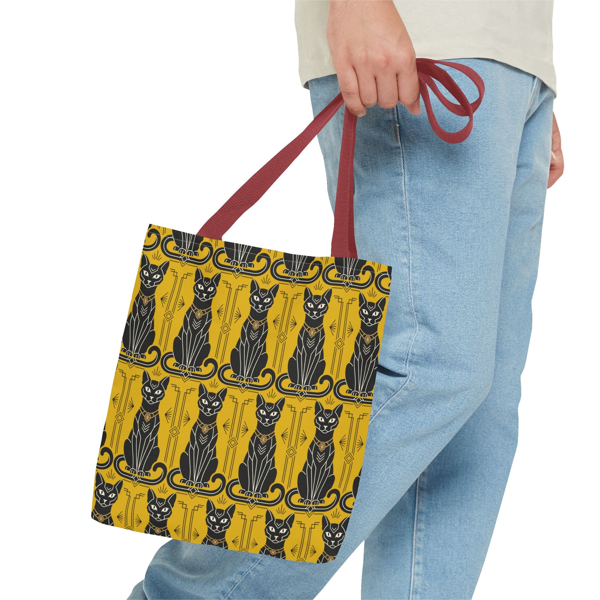 Yellow tote bag with black Art Nouveau cat pattern held by red handles
