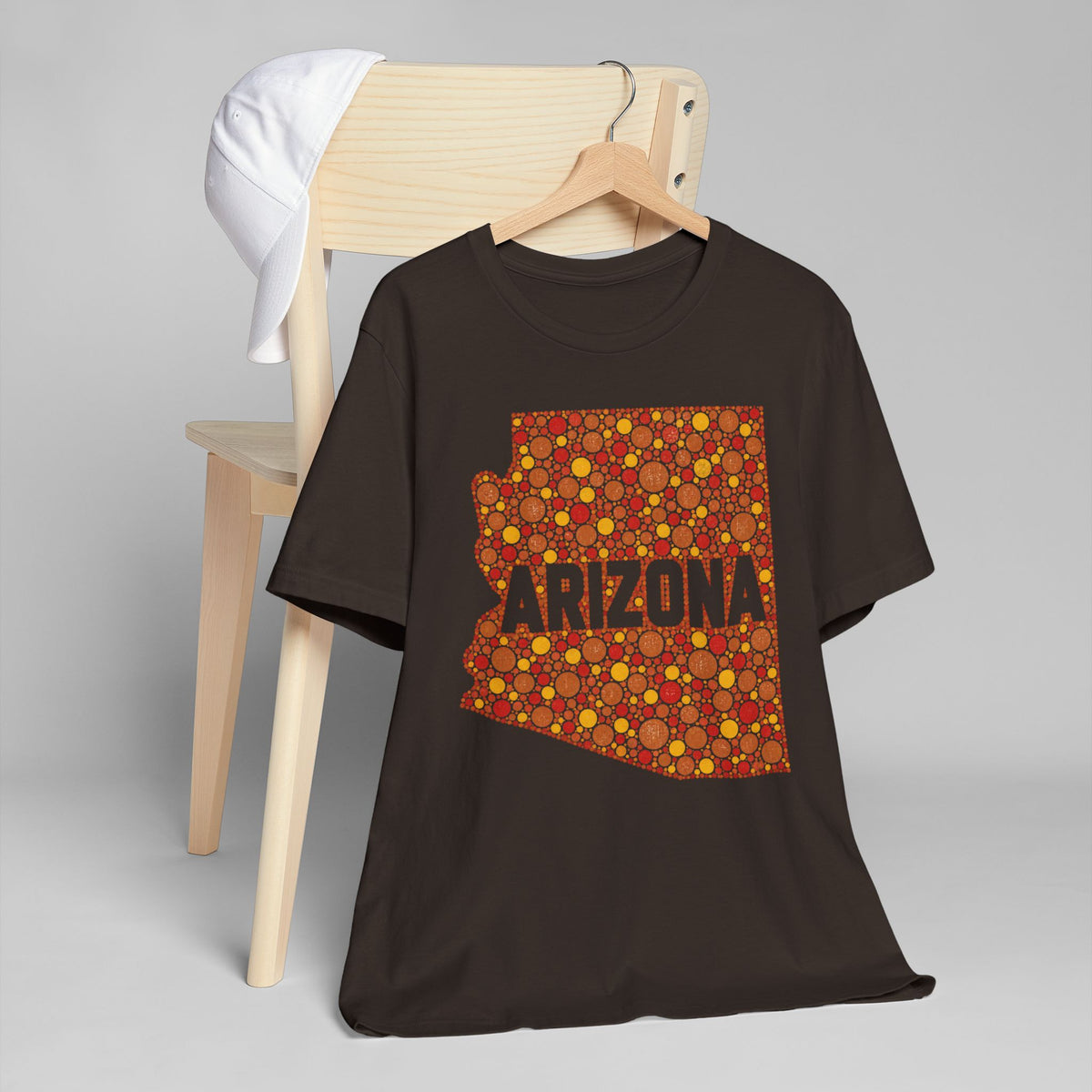 Dark brown short-sleeve t-shirt with orange patterned Arizona outline graphic