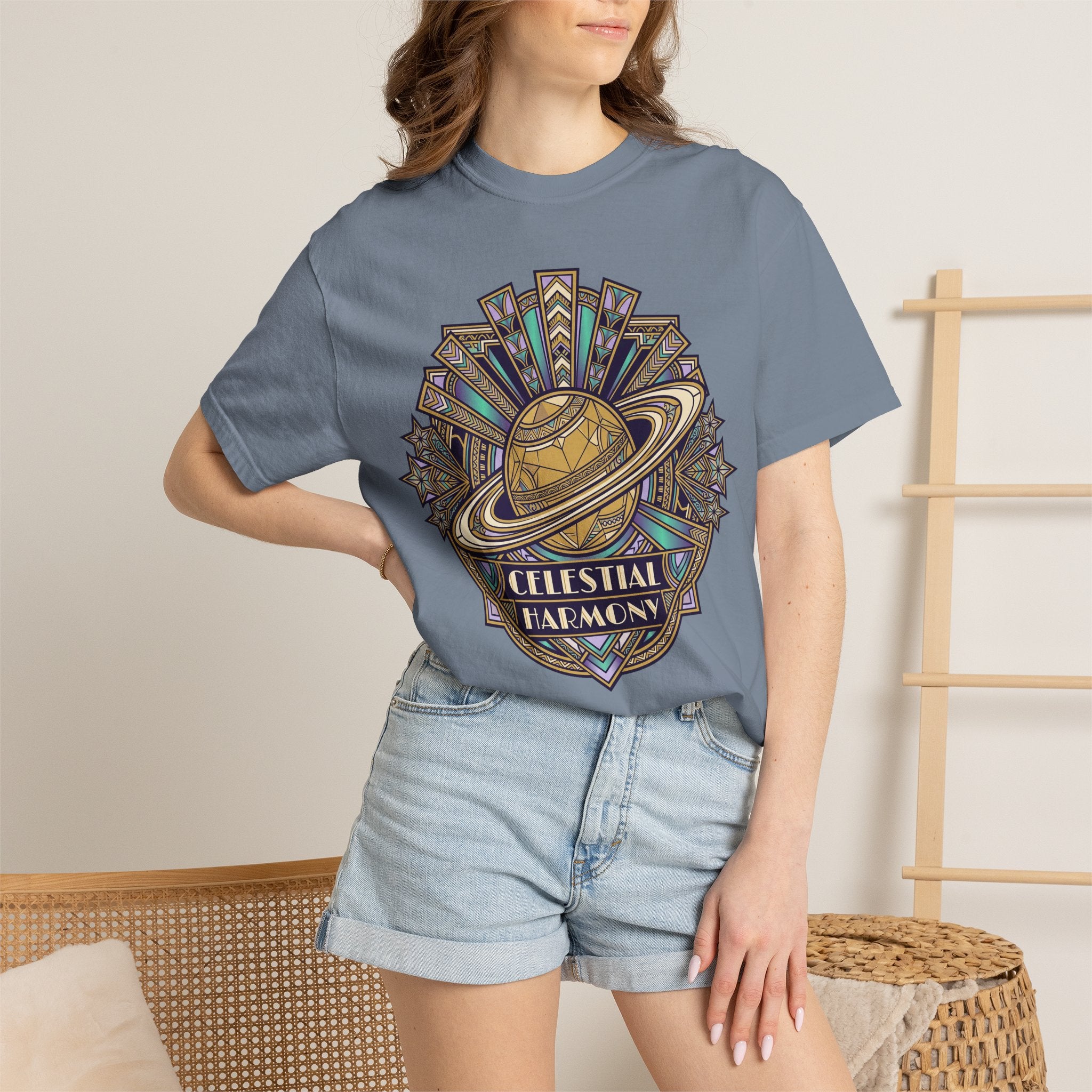 Blue t-shirt worn by model, featuring a celestial planet and rings front graphic