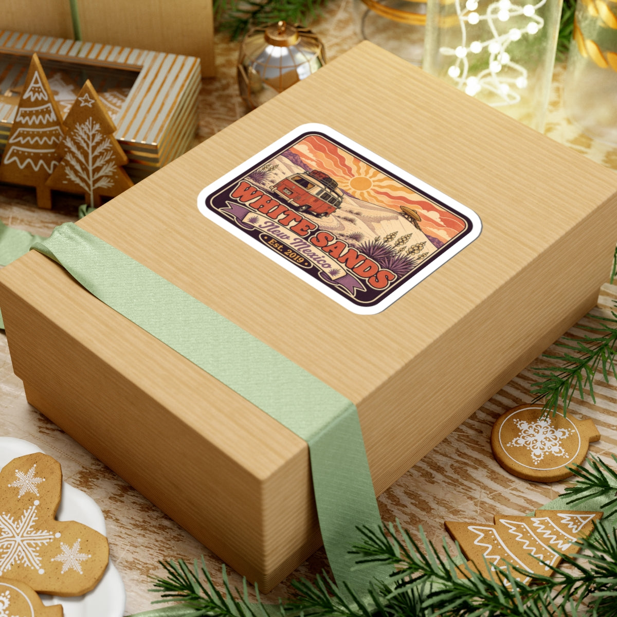 Vinyl sticker on gift box with desert sun, cacti, and White Sands lettering