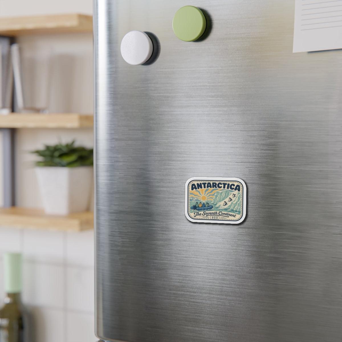 Die-cut Antarctica patch magnet on a stainless refrigerator, small rounded rectangle with vintage scene