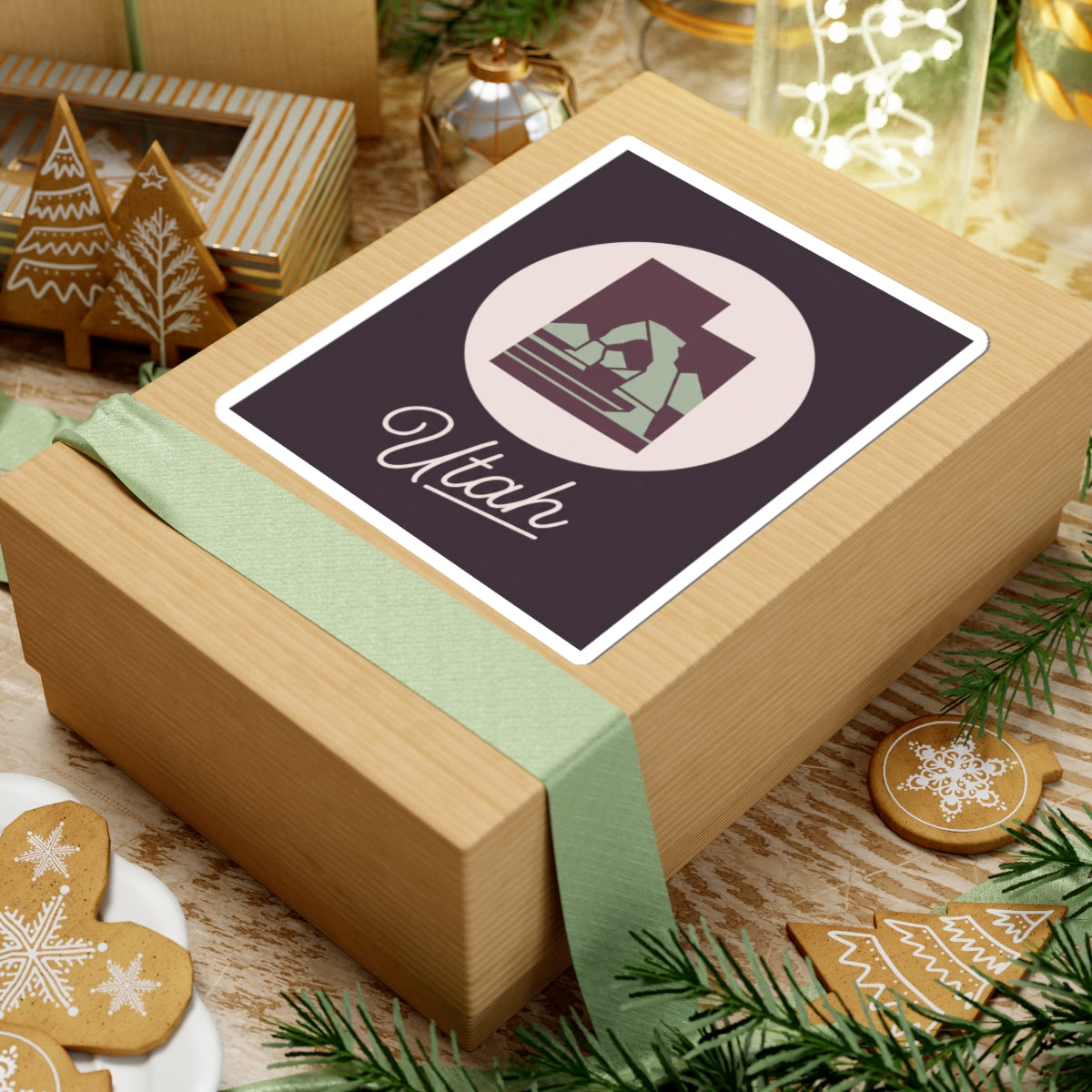 Utah state decal sticker on a wrapped gift, dark purple square with circular mountain and “Utah”.