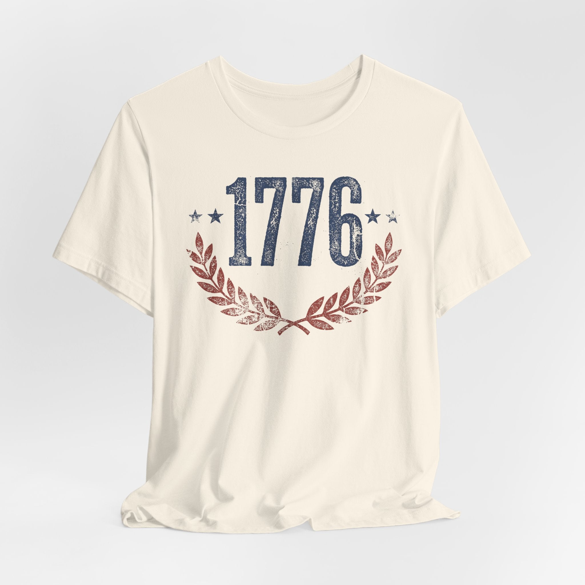 Cream T-shirt with centered “1776” graphic and laurel wreath design