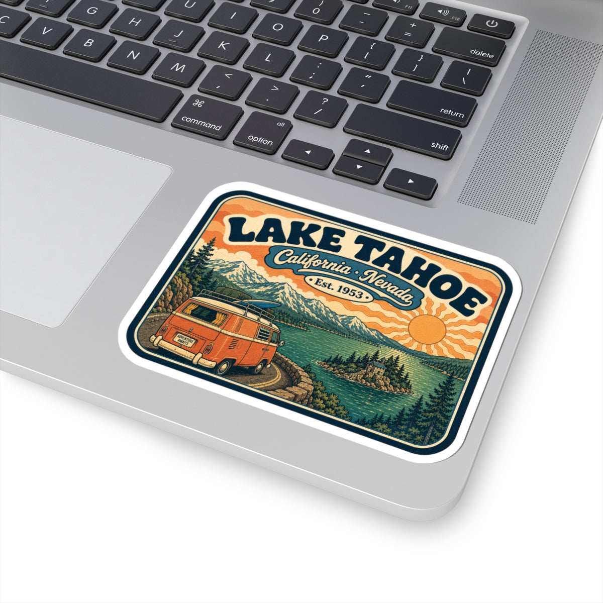 Kiss-cut Lake Tahoe sticker on a laptop, vintage camper van scene with California Nevada text.