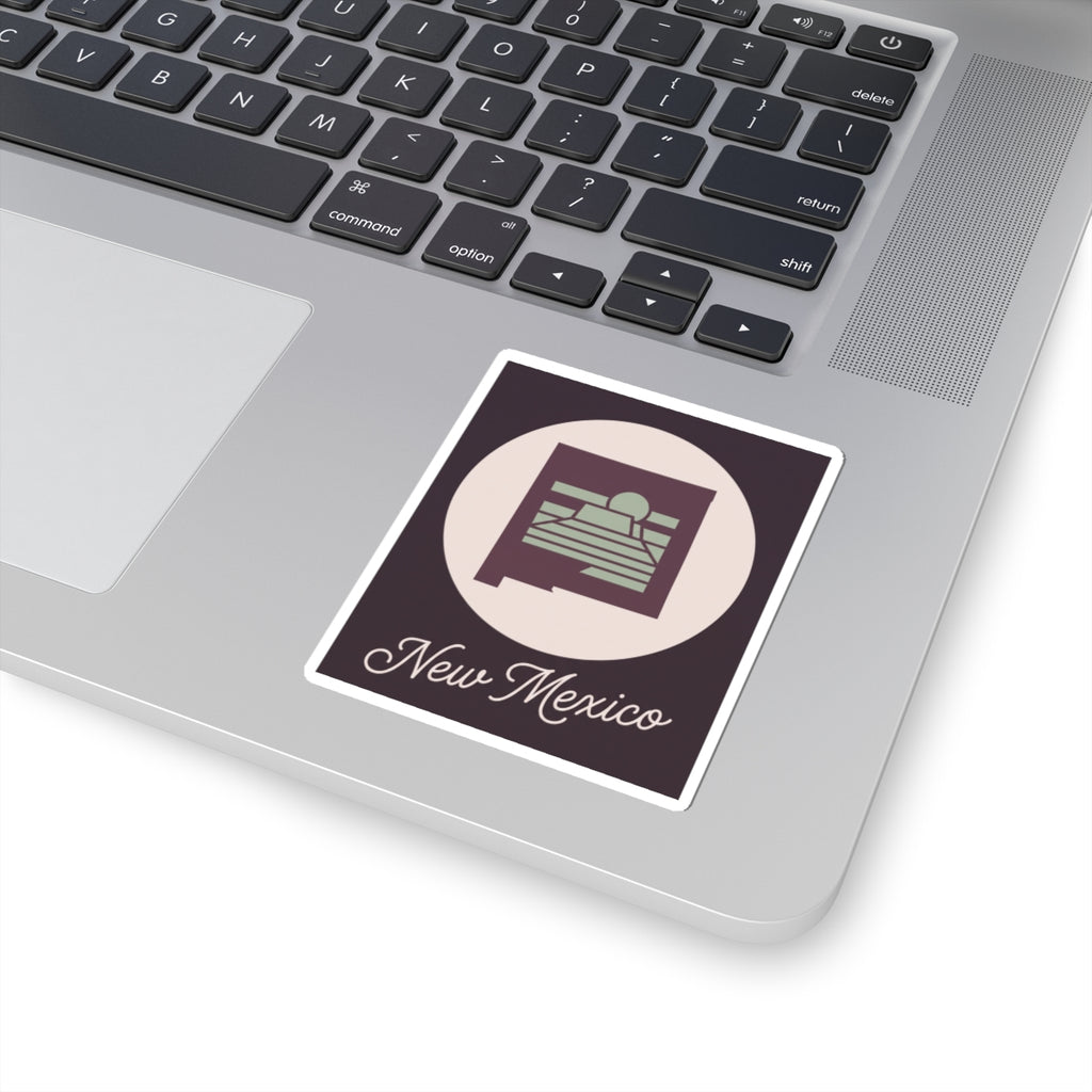 New Mexico sticker decal on laptop lid with circular desert sunrise and “New Mexico” script
