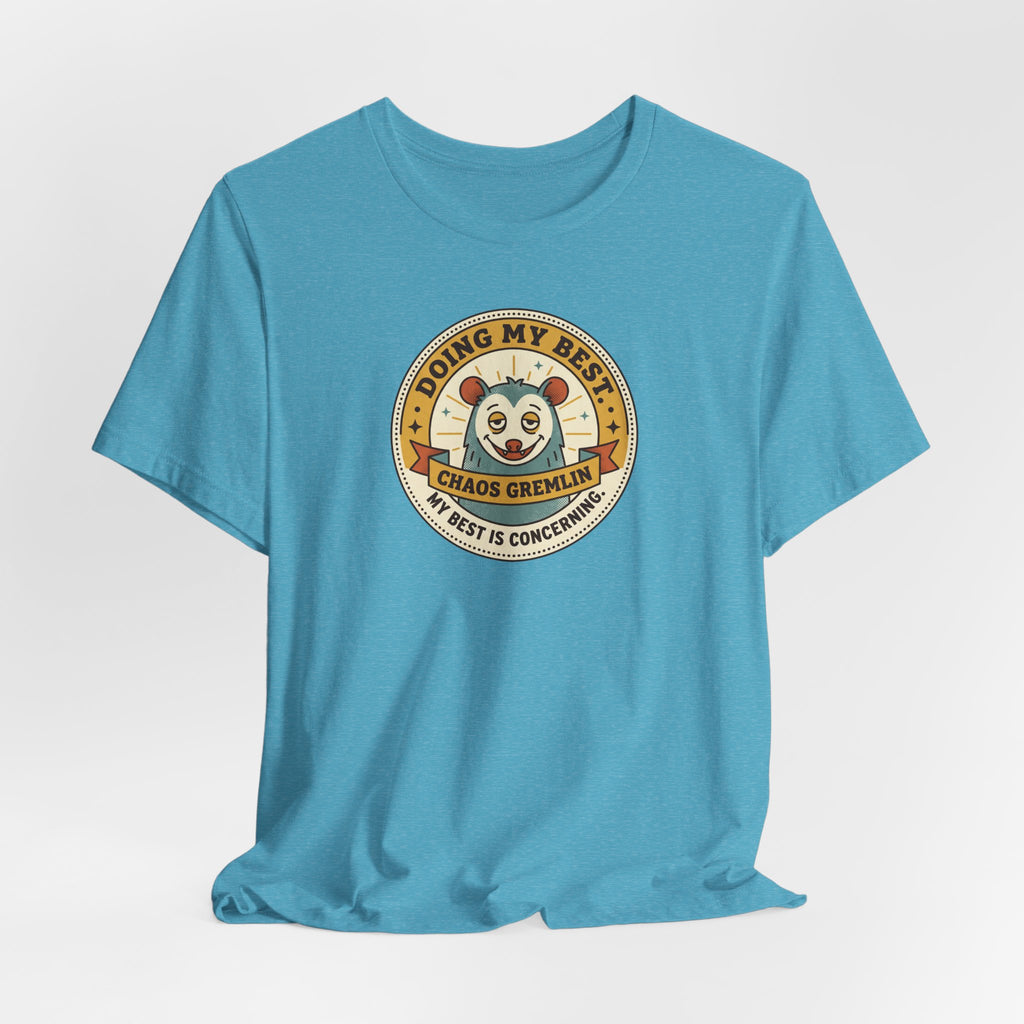 Light blue crew-neck T-shirt with round gremlin badge design on the chest