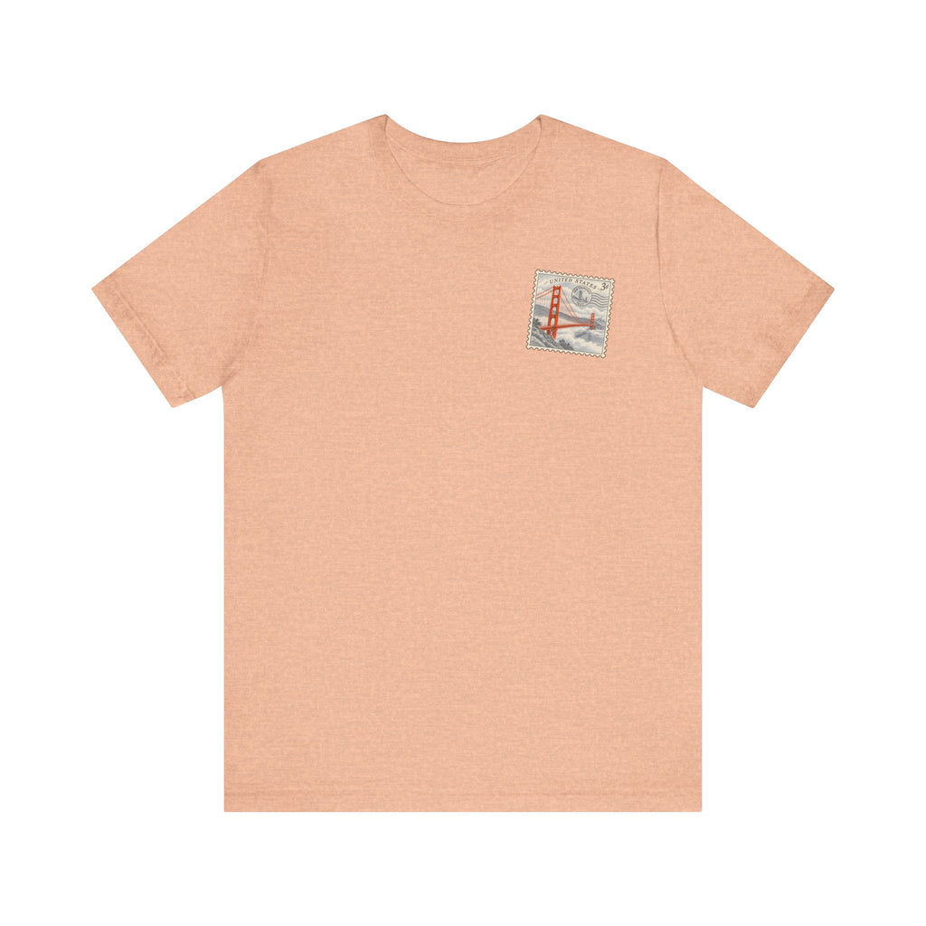 Peach graphic tee with small Golden Gate Bridge chest emblem