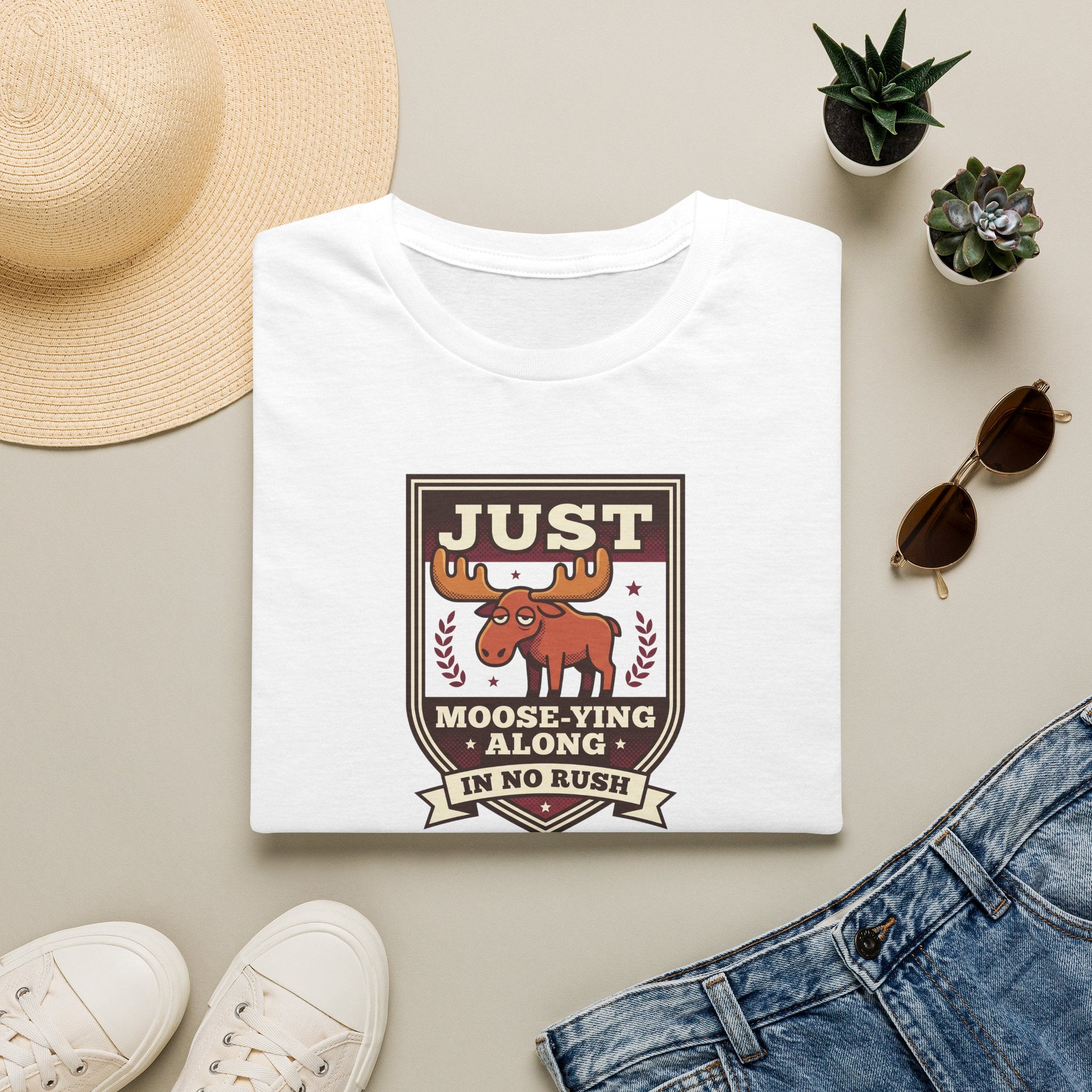 White crewneck T-shirt with “Just Moose-ying Along” moose graphic on chest