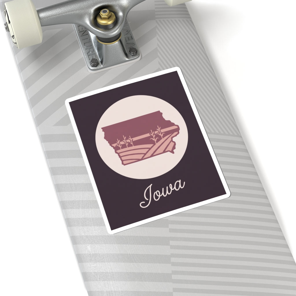 Mauve Iowa state silhouette kiss-cut sticker with “Iowa” script, pale circle, square bordered design