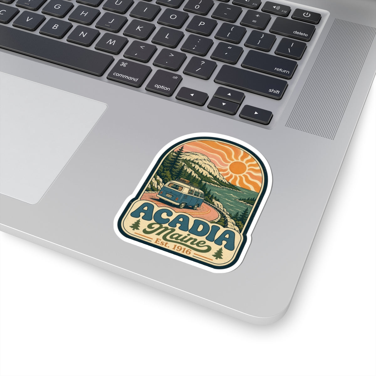 Acadia Maine kiss-cut sticker on a laptop, retro camper van, orange sun, Est. 1916