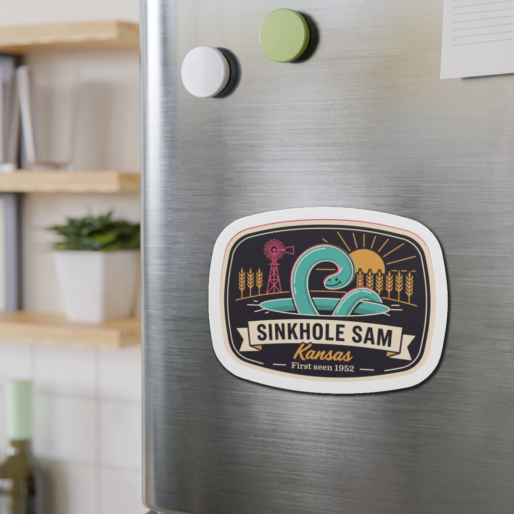 Oval die-cut sticker-style magnet with Sinkhole Sam Kansas artwork and white border