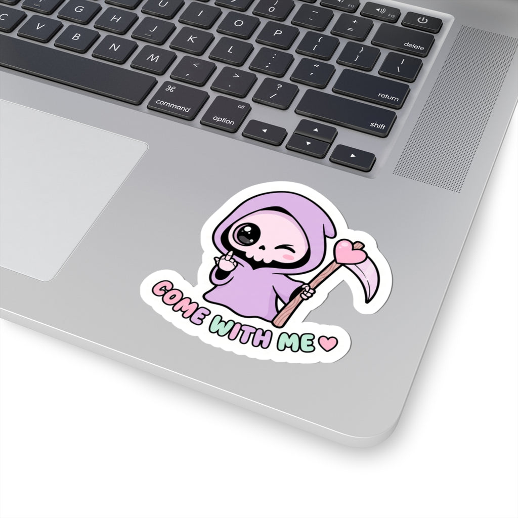Purple grim reaper sticker on a laptop keyboard, heart scythe design reading “COME WITH ME”.