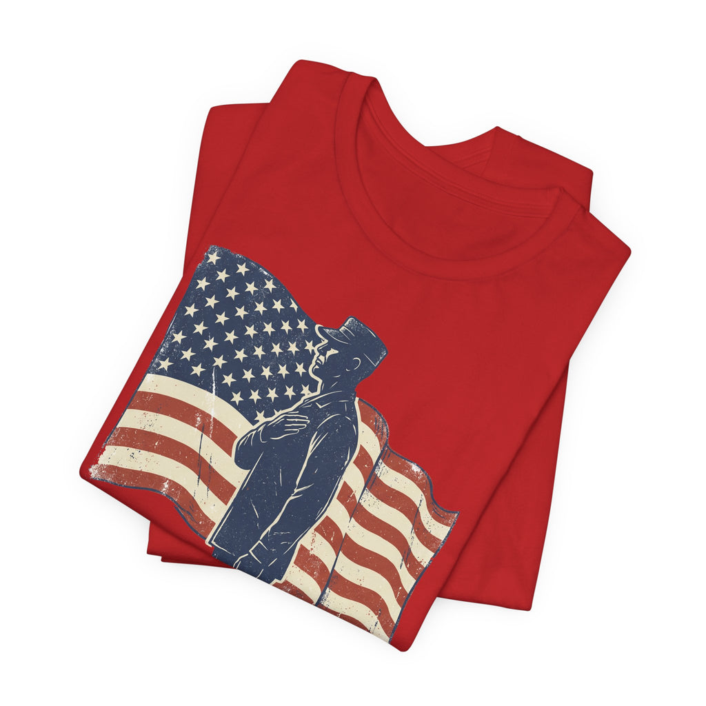 Red crewneck T-shirt with saluting soldier and American flag graphic, folded