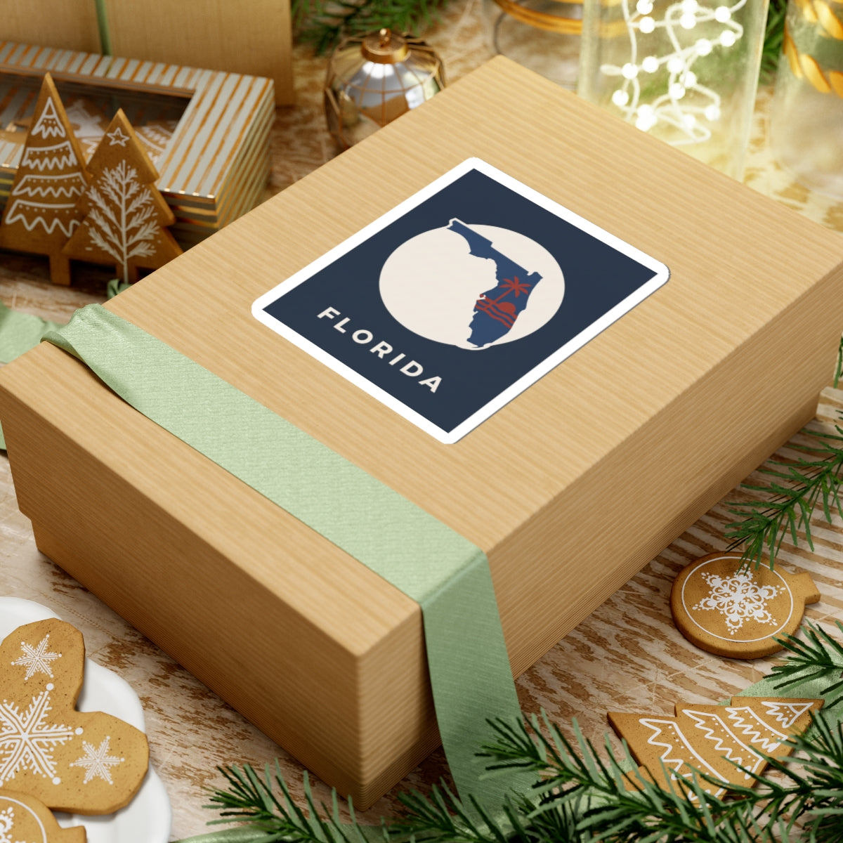 Florida sticker on wrapped gift: blue square with white circle, red palm tree, 'FLORIDA'