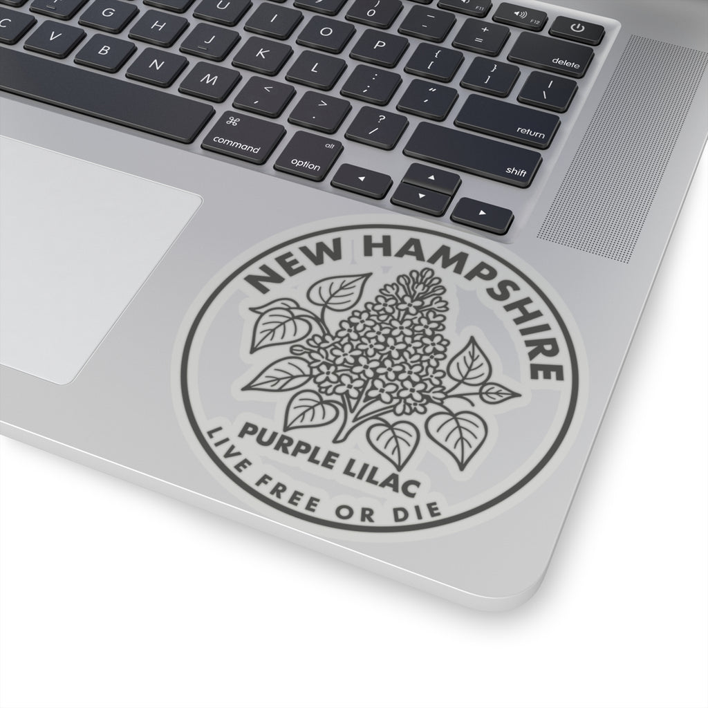 Round transparent-vinyl decal on laptop lid with purple lilac floral crest