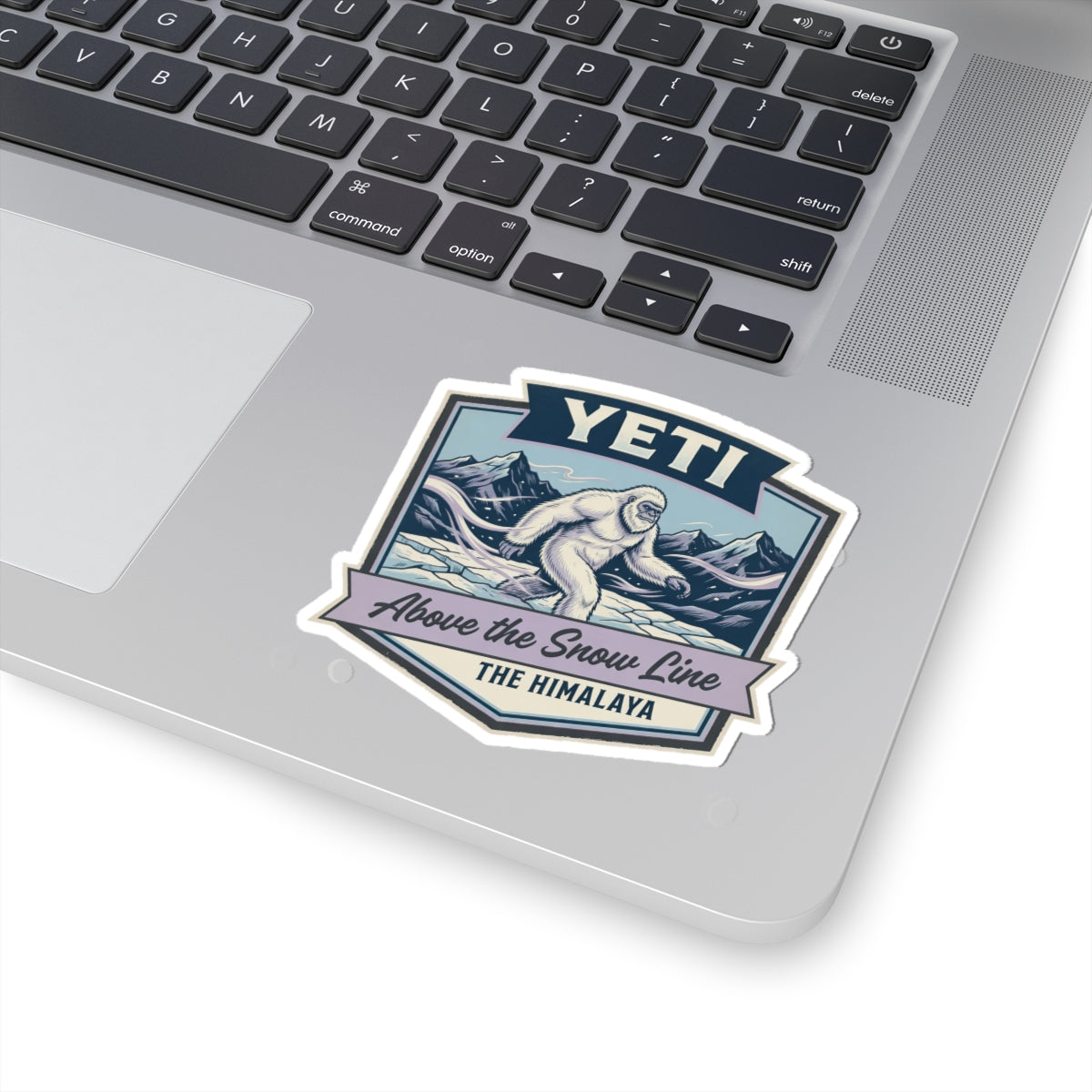 YETI die-cut sticker on laptop with Himalayan sasquatch above the snow line