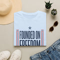 Light blue graphic T-shirt with "Founded on Freedom" text and blue star