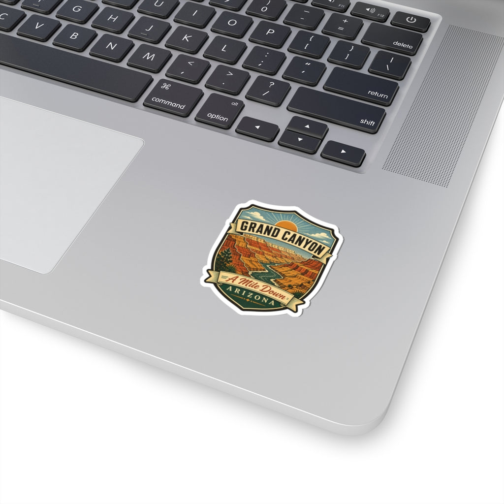Shield-style travel sticker on laptop with vintage canyon scene and Arizona badge design