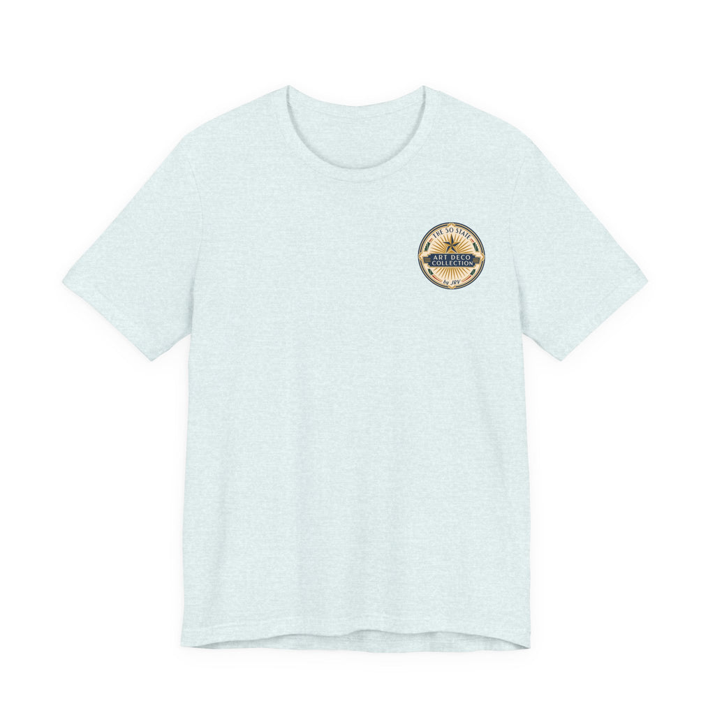 Light heather blue T-shirt with small circular badge on left chest