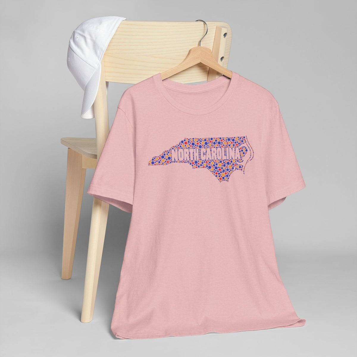 Pink crewneck T-shirt with colorful North Carolina floral map graphic