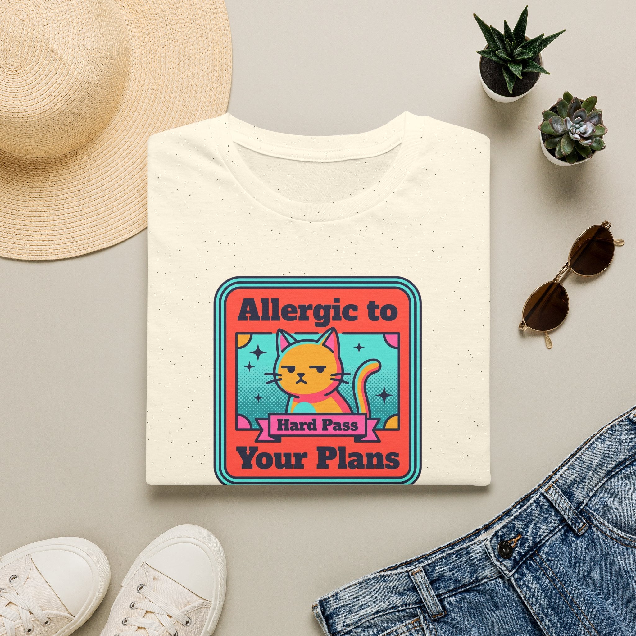 Cream cat graphic T-shirt with 'Allergic to Your Plans' text
