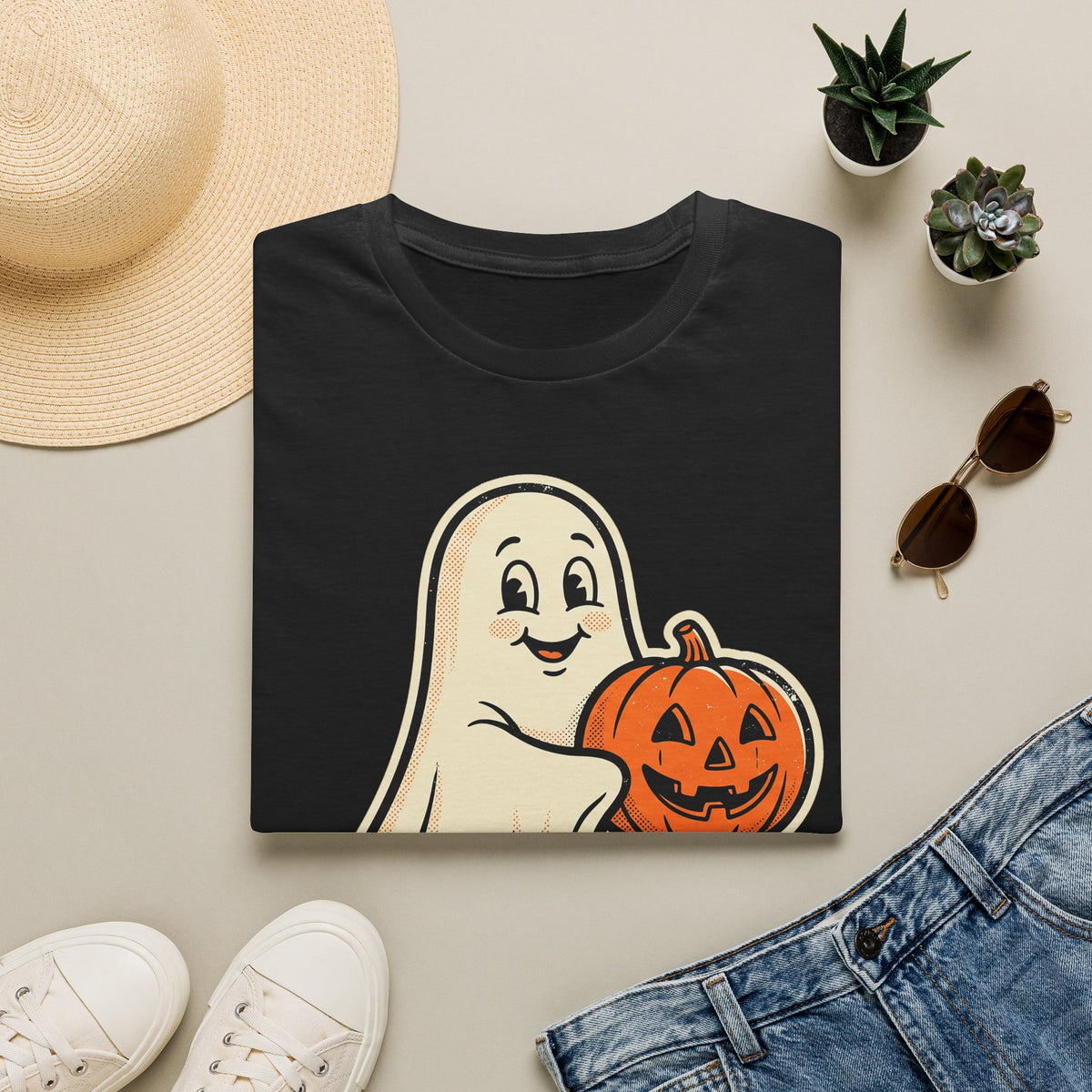 Black Halloween graphic T-shirt with friendly ghost holding a jack-o'-lantern pumpkin.