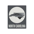 Dark gray North Carolina lighthouse metal wall sign with white state and “NORTH CAROLINA”